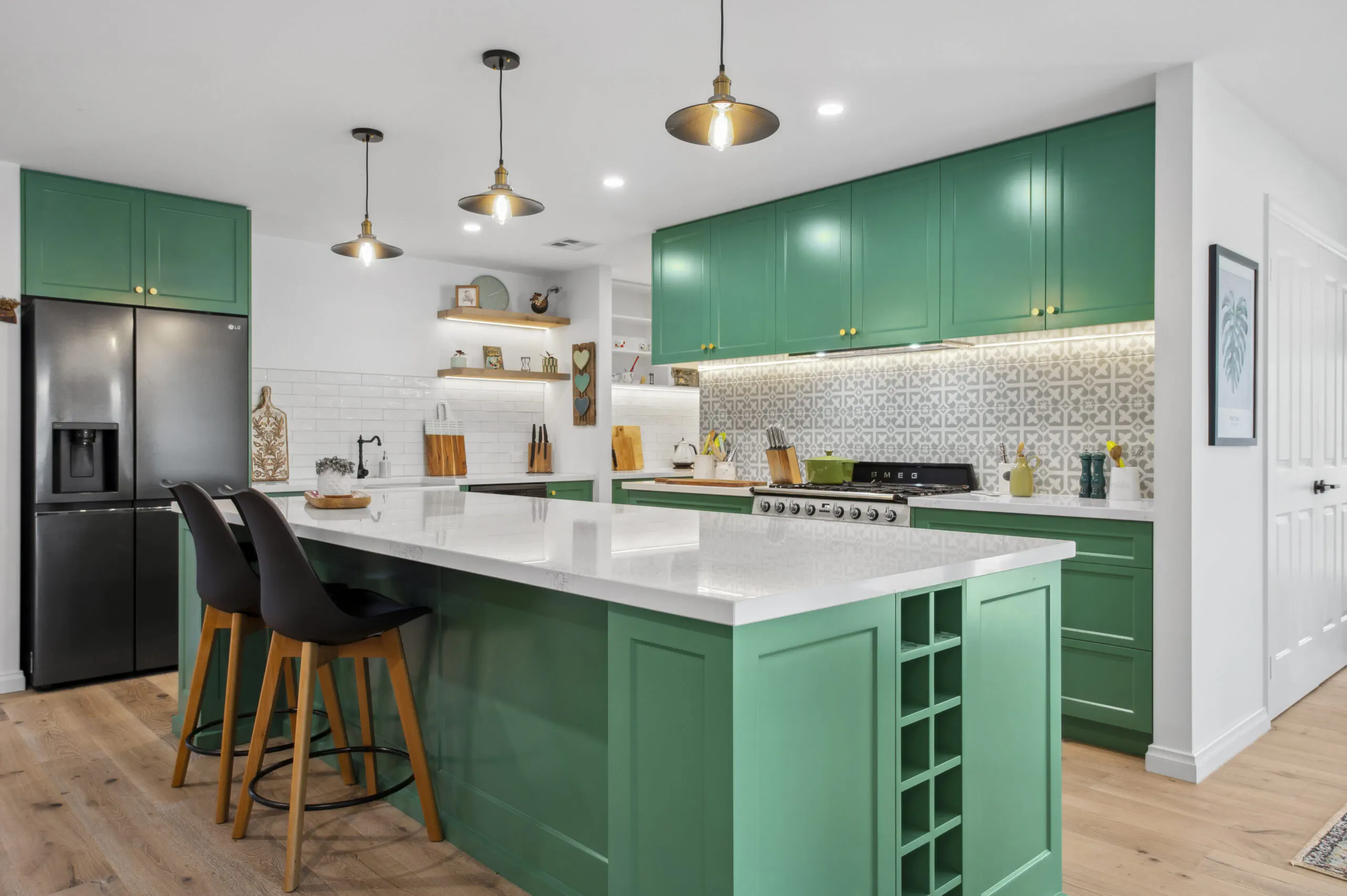 Green kitchen island with a built-in wine rack