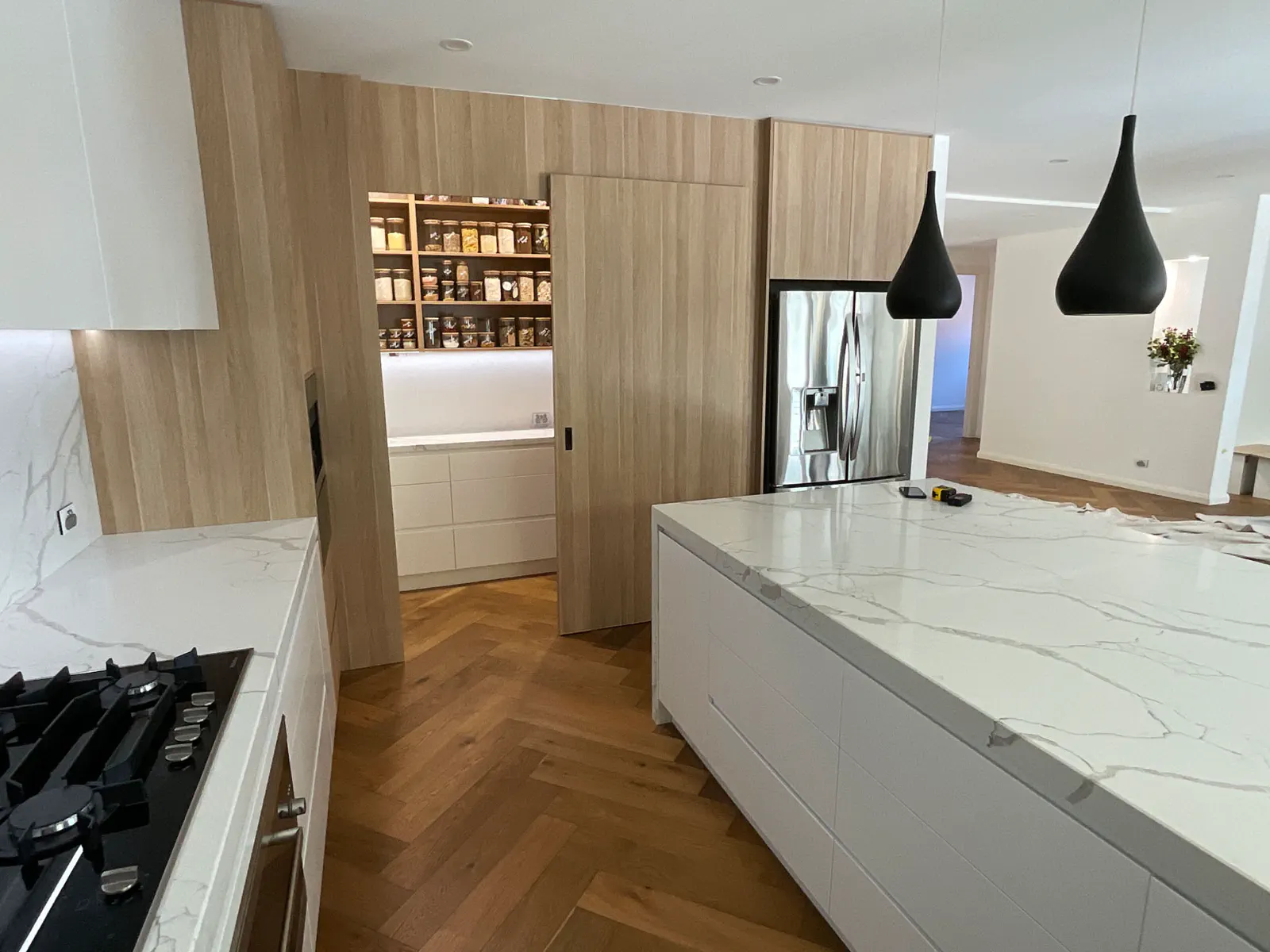 Timber and white kitchen with a herringbone floor