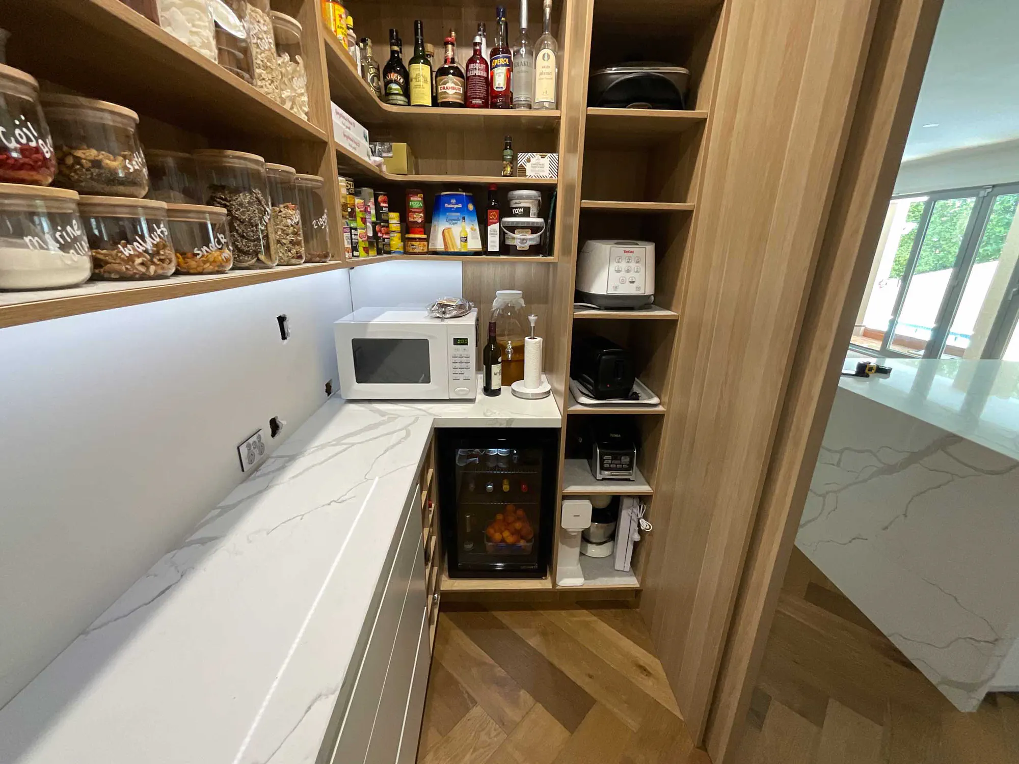 Walk-in pantry with timber shelving